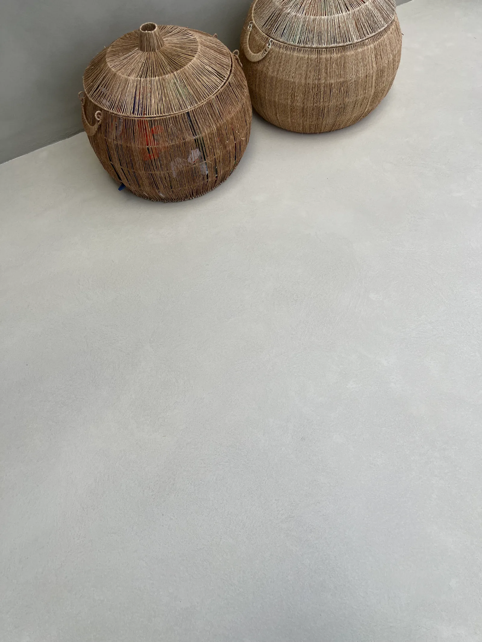Honey 2 floor in daylight beside a vase and two woven baskets in the sunroom